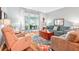 Bright living room boasts hardwood floors, comfortable seating, and natural light at 26821 Augusta Springs Cir, Leesburg, FL 34748