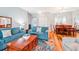 Open-concept living room with stylish hardwood floors and comfortable seating at 26821 Augusta Springs Cir, Leesburg, FL 34748