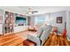 Bright living room with a cozy seating area and an entertainment center at 26821 Augusta Springs Cir, Leesburg, FL 34748