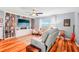 Inviting living room featuring a bookcase, comfortable seating, and bright natural light at 26821 Augusta Springs Cir, Leesburg, FL 34748