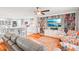 Open-concept living room featuring a built-in bookcase and modern decor at 26821 Augusta Springs Cir, Leesburg, FL 34748