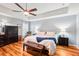 Serene main bedroom with a tray ceiling and wood flooring at 26821 Augusta Springs Cir, Leesburg, FL 34748