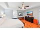 Serene main bedroom with hardwood floors, dark wood furniture, and a ceiling fan for added comfort and style at 26821 Augusta Springs Cir, Leesburg, FL 34748