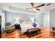 Relaxing main bedroom with tray ceiling and a comfortable seating area at 26821 Augusta Springs Cir, Leesburg, FL 34748