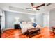 Spacious main bedroom with a tray ceiling, large window and modern furniture at 26821 Augusta Springs Cir, Leesburg, FL 34748