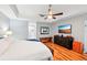 The main bedroom features a ceiling fan, wood floors, and ensuite bathroom access at 26821 Augusta Springs Cir, Leesburg, FL 34748