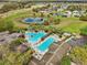 Aerial view of the community pool featuring palm trees, pergolas, and a lap pool at 26821 Augusta Springs Cir, Leesburg, FL 34748