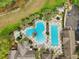 Aerial view of a community pool with spa, lounge area, and lush landscaping at 26821 Augusta Springs Cir, Leesburg, FL 34748