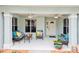 Inviting front porch with comfortable seating, ceiling fans, and a welcoming entrance at 26821 Augusta Springs Cir, Leesburg, FL 34748