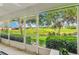 Enjoy gorgeous golf course views from this screened lanai with manicured bushes and tropical plants at 26821 Augusta Springs Cir, Leesburg, FL 34748