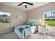 Cozy bedroom with two windows, a comfortable bed, and a bedside table at 288 Bent Oak Ct, Leesburg, FL 34748