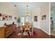 Inviting dining room with hardwood floors, stylish light fixture, and access to outdoor space at 288 Bent Oak Ct, Leesburg, FL 34748