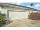 A two car garage and driveway with updated landscaping adds curb appeal to this home at 288 Bent Oak Ct, Leesburg, FL 34748