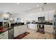 Well-equipped kitchen with updated appliances, black countertops, and ample cabinet space at 288 Bent Oak Ct, Leesburg, FL 34748