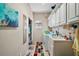 Functional laundry room with a sink, washing machine, dryer, and plenty of storage cabinets at 288 Bent Oak Ct, Leesburg, FL 34748