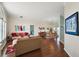 Open-concept living room and dining area featuring hardwood floors and elegant decor at 288 Bent Oak Ct, Leesburg, FL 34748