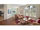 Bright living room with hardwood floors, shutters, and stylish furnishings at 288 Bent Oak Ct, Leesburg, FL 34748