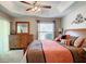 Bright main bedroom featuring a tray ceiling, ceiling fan, and a large window providing great natural light at 3076 Gulfport Ct, The Villages, FL 32163