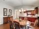 Well-lit dining area with hardwood flooring that flows into an open kitchen at 3076 Gulfport Ct, The Villages, FL 32163