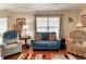 Comfortable living room featuring hardwood floors, with great natural light coming in from a large window at 3076 Gulfport Ct, The Villages, FL 32163