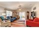 Bright and airy living room with hardwood floors and a ceiling fan at 3076 Gulfport Ct, The Villages, FL 32163