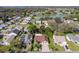 An aerial view shows the neighborhood, a lake, and mature landscaping at 314 Chula Vista Ave, Lady Lake, FL 32159