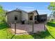 Home backyard featuring outdoor patio area, with shade coverings, mature trees and lawn at 314 Chula Vista Ave, Lady Lake, FL 32159