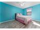 This bedroom features modern wood floors, a bright blue design, and ample space at 314 Chula Vista Ave, Lady Lake, FL 32159