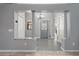 Bright foyer featuring tile flooring, decorative glass door, columns, and a view into other living spaces at 314 Chula Vista Ave, Lady Lake, FL 32159