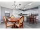 Bright kitchen with white cabinetry, an island with seating, and an adjacent dining area with wood table at 314 Chula Vista Ave, Lady Lake, FL 32159