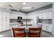 Bright kitchen featuring white cabinetry, granite counters, gray backsplash and a large center island at 314 Chula Vista Ave, Lady Lake, FL 32159