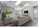 Inviting living room with wood floors, a ceiling fan, neutral furniture and plenty of natural light at 314 Chula Vista Ave, Lady Lake, FL 32159