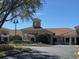 Community clubhouse featuring a tiled roof, fountain, and manicured landscaping at 3201 Sonesta Ct # B, Clermont, FL 34711