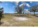 Large open green space with mature trees, bordered with a fence and green space with native plantings for a natural setting at 3201 Sonesta Ct # B, Clermont, FL 34711