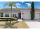 Inviting townhome showcasing well-manicured landscaping, paver driveway, and a charming covered entryway at 3201 Sonesta Ct # B, Clermont, FL 34711