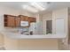 Open-concept kitchen with plenty of counter space, white appliances and a view of the laundry area at 3201 Sonesta Ct # B, Clermont, FL 34711