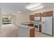 Well-lit kitchen with a wrap-around counter overlooking the adjacent living area and white appliances at 3201 Sonesta Ct # B, Clermont, FL 34711