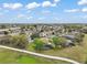 Expansive aerial view showcasing the neighborhood's community, landscaped yards, and surrounding natural beauty at 3320 Callerton Rd, Clermont, FL 34714