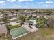 Overhead view of community amenities, including a pool, playground, and basketball court, all surrounded by well-maintained homes at 3320 Callerton Rd, Clermont, FL 34714