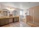 Bathroom featuring a dual sink vanity, soaking tub, and glass-enclosed shower at 3320 Callerton Rd, Clermont, FL 34714