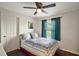 Bright bedroom features a patterned quilt, painting and a window with green curtains at 3320 Callerton Rd, Clermont, FL 34714