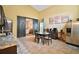 Dining area with a tile floor, a dark wooden table, four chairs and black barn doors at 3320 Callerton Rd, Clermont, FL 34714