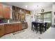 Well-lit kitchen featuring modern appliances, wooden cabinets, a stylish backsplash, and an adjacent dining area at 3320 Callerton Rd, Clermont, FL 34714