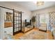 Bright living room with hardwood floors, modern decor, and barn doors leading to the kitchen at 3320 Callerton Rd, Clermont, FL 34714