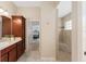 Bathroom with walk-in shower, tile flooring, and wood vanity at 3403 Rabbit Run Path, The Villages, FL 32163