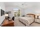 Bedroom features large window, a desk, a bed, and a nightstand at 3403 Rabbit Run Path, The Villages, FL 32163