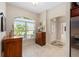 Bright dining area featuring tile floors, a large picture window, and a wooden hutch at 3403 Rabbit Run Path, The Villages, FL 32163