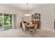 Dining area featuring an oval table, a chandelier, and sliding glass doors at 3403 Rabbit Run Path, The Villages, FL 32163