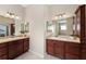 View of the main bathroom showing the double sinks, vanities, and cabinets at 3403 Rabbit Run Path, The Villages, FL 32163