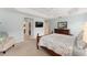 Bright main bedroom with a ceiling fan, tray ceiling, carpeted floors, and neutral walls at 3403 Rabbit Run Path, The Villages, FL 32163